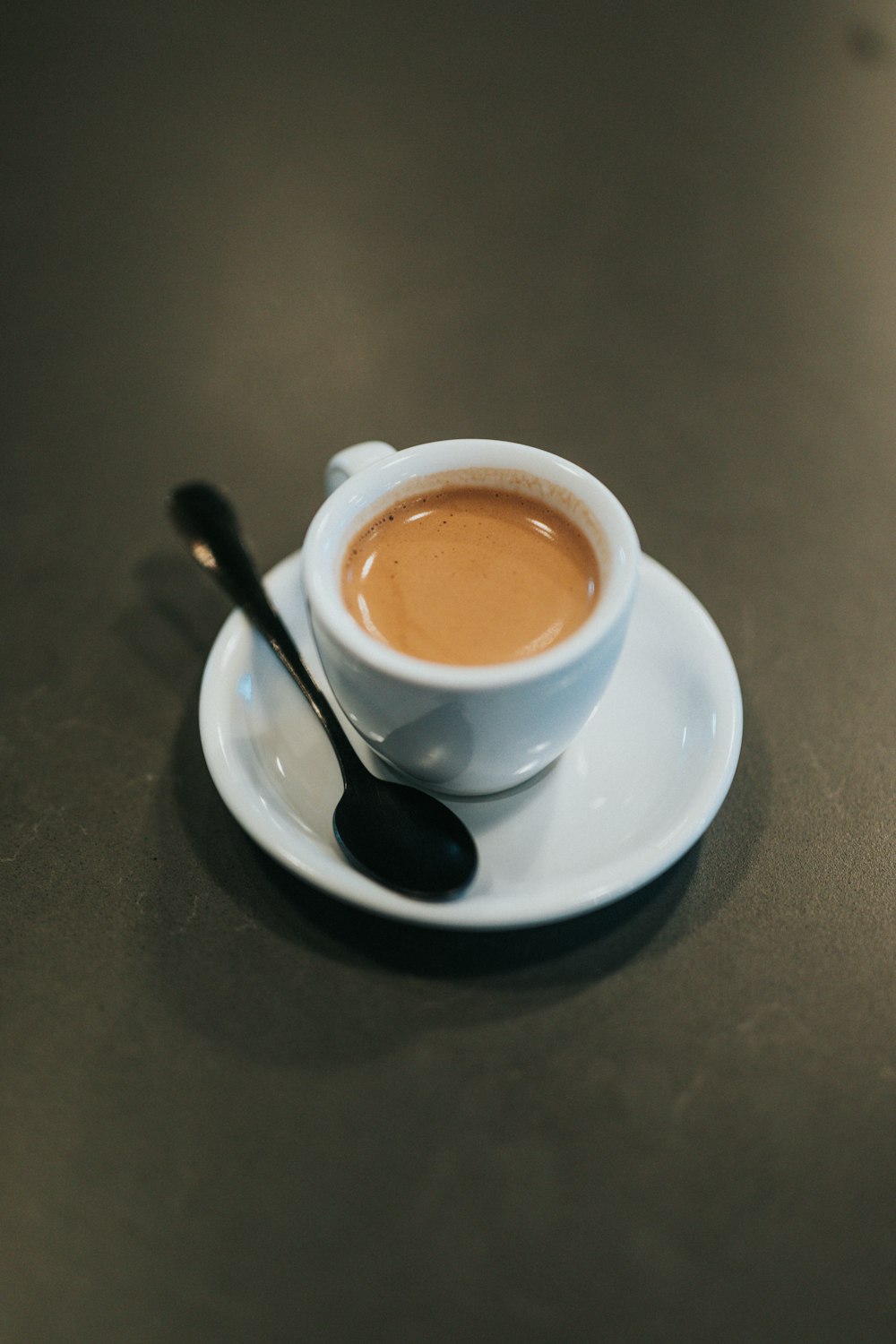 white ceramic cup with brown liquid