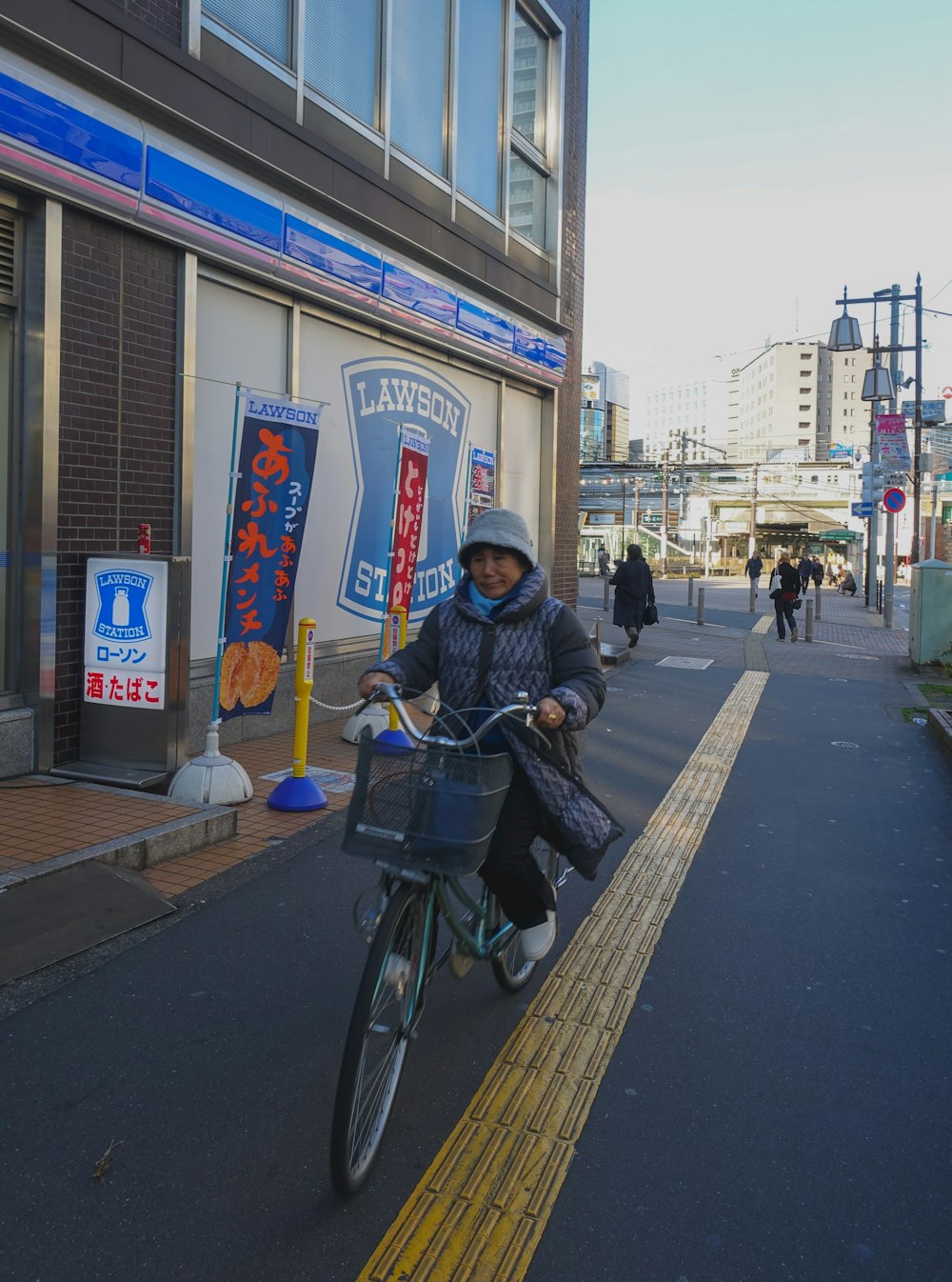 man in black jacket riding bicycle on sidewalk during daytime