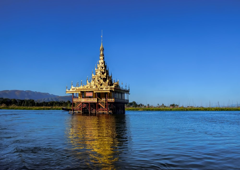 brown and white wooden house on body of water during daytime