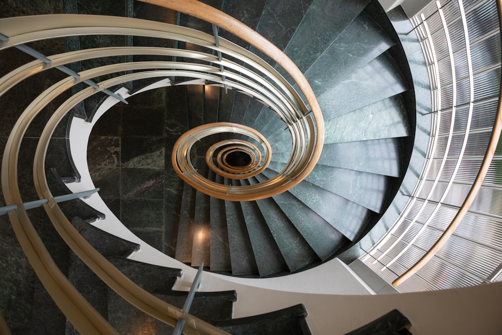 gray spiral staircase with white metal railings