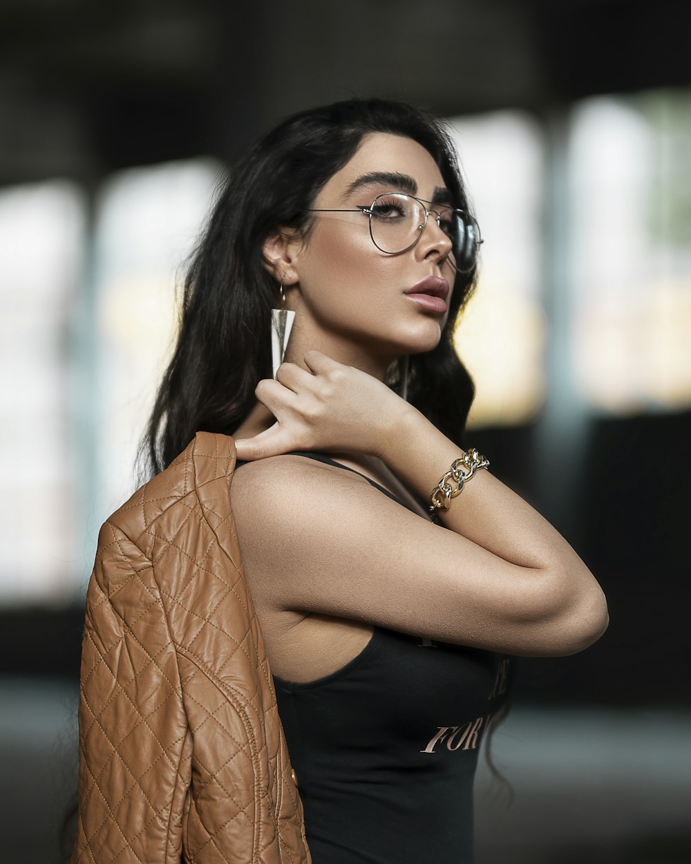 woman in black tank top wearing black framed eyeglasses