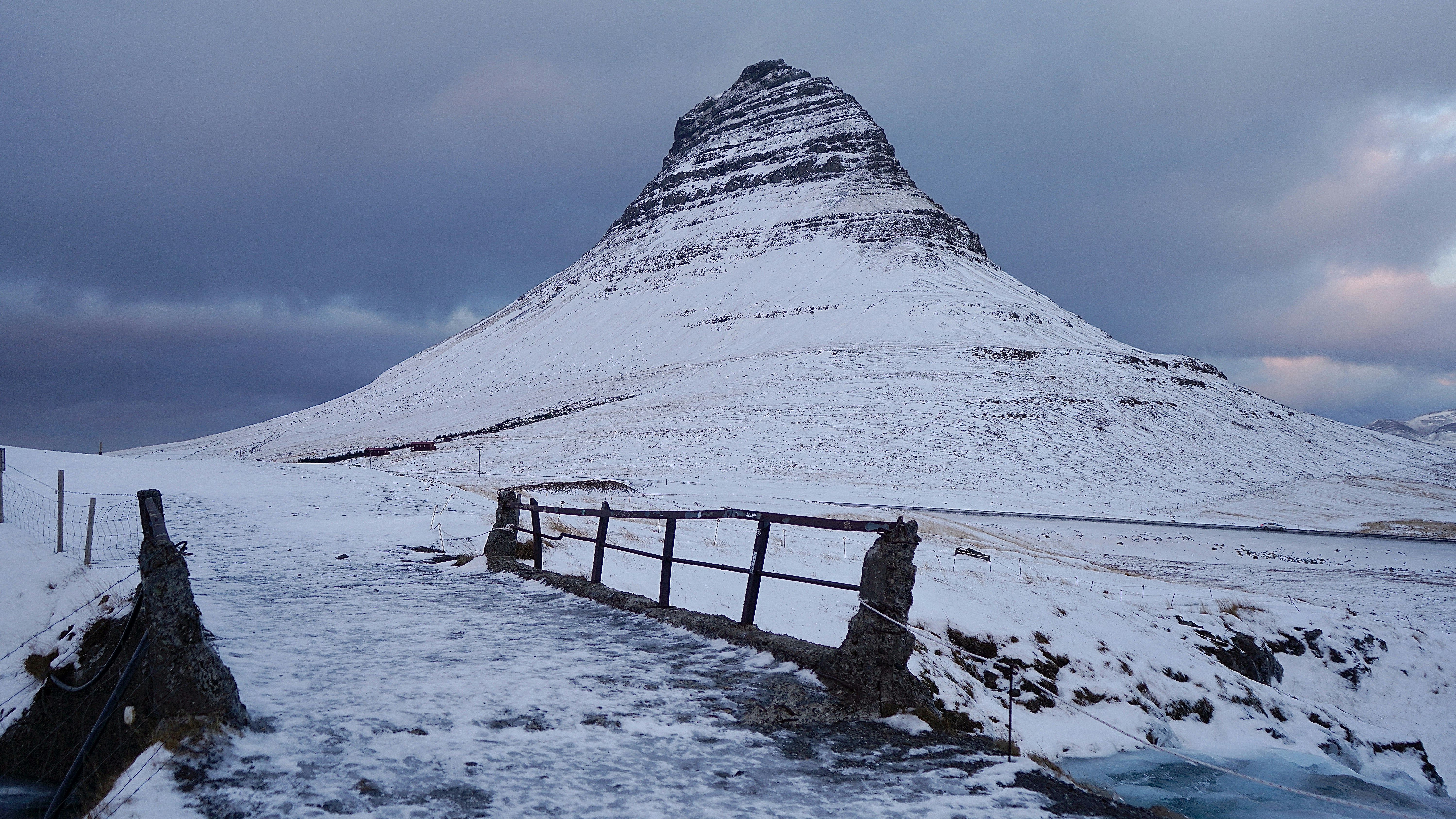 brown wooden bench on snow covered ground