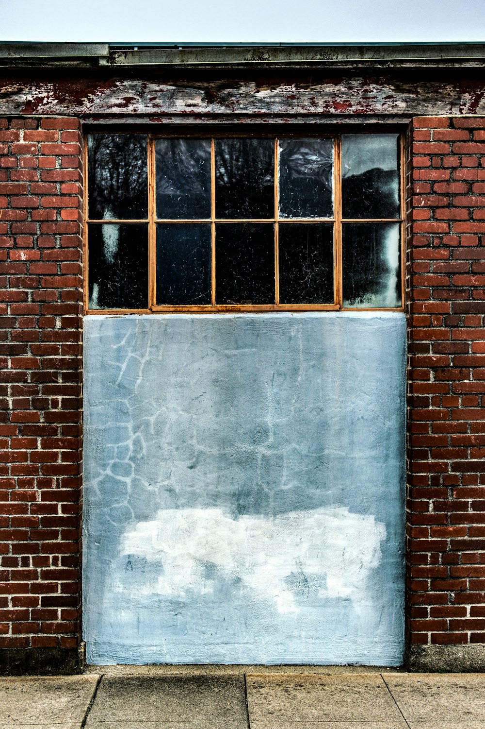 brown brick wall with white wooden window