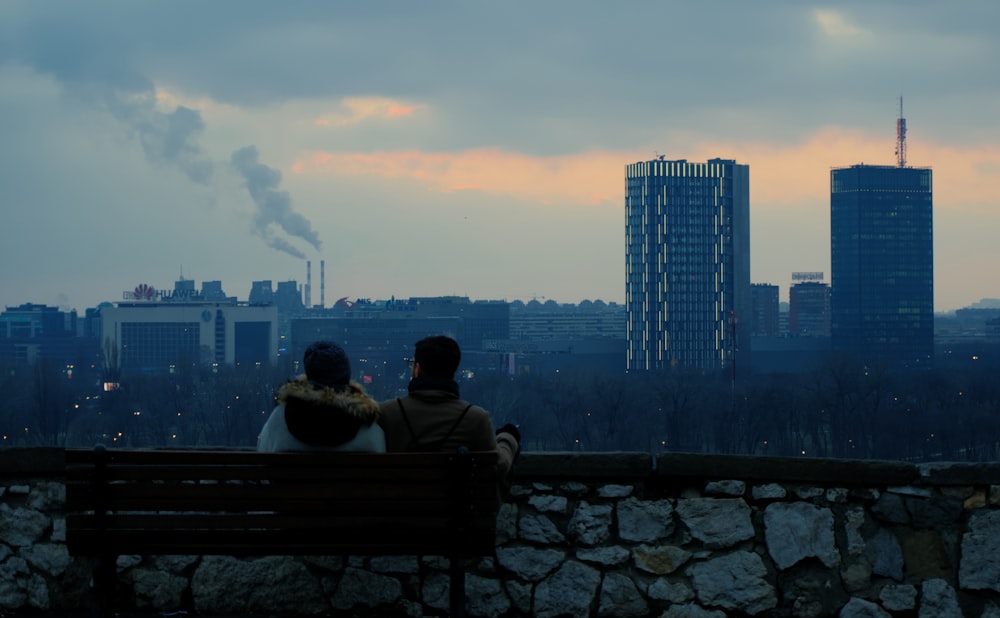 couple sitting on bench during sunset