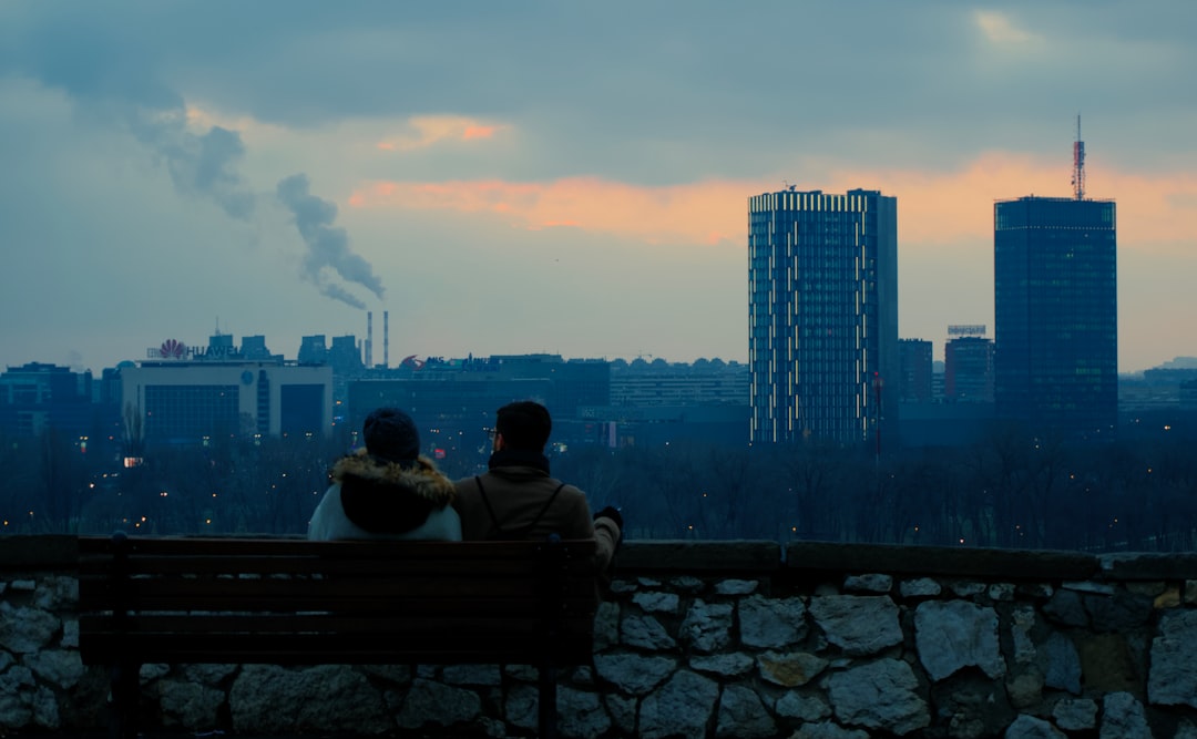 couple sitting on bench during sunset