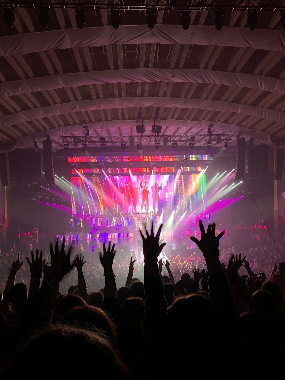 people standing on stage with lights