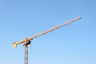 yellow crane under blue sky during daytime