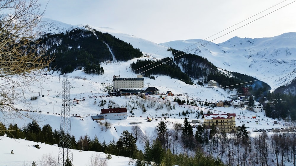 white and brown house on snow covered mountain during daytime