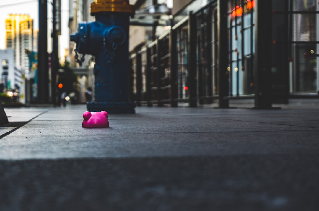 pink heart pillow on gray concrete road