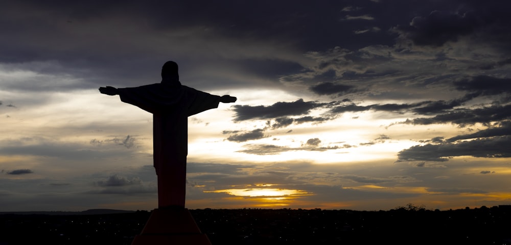 silhouette of statue during sunset