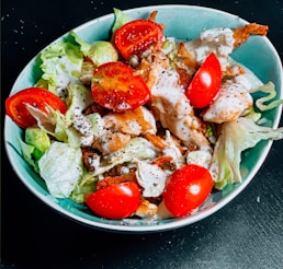 vegetable salad on blue ceramic bowl