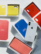 Array of colorful iPhone cases fanned out on a white surface