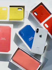 Display of the Voltek case in multiple colors arranged artistically on different iPhone models.