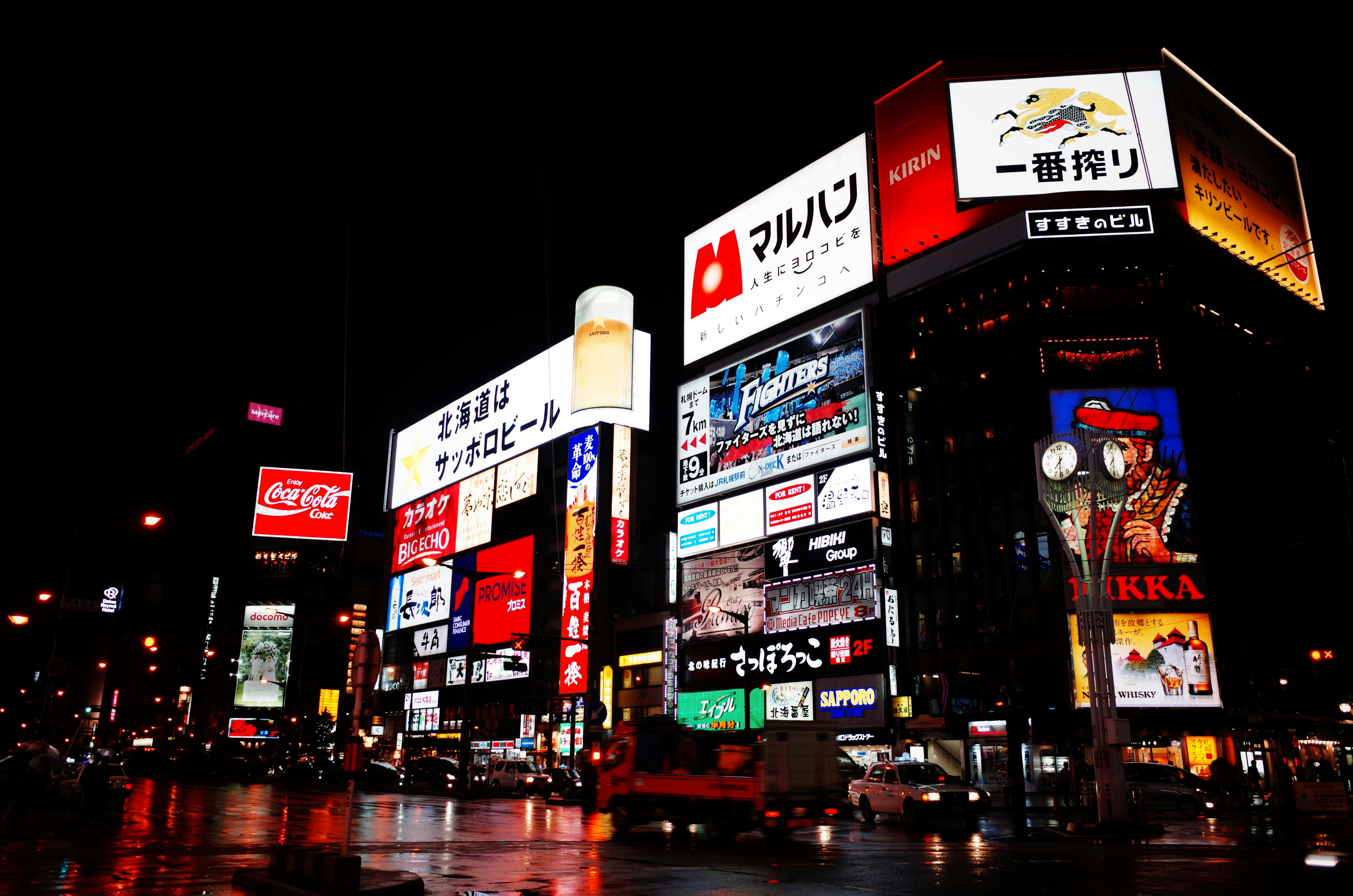 red and white kanji text signage, A night view of Sapporo