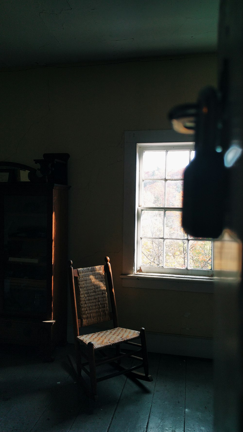 brown wooden chair near window