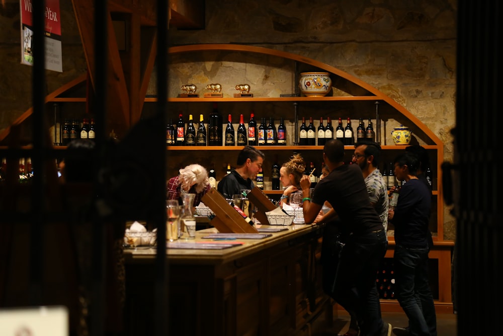 people standing in front of brown wooden table