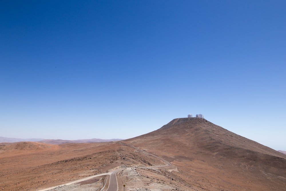 brown mountain under blue sky during daytime