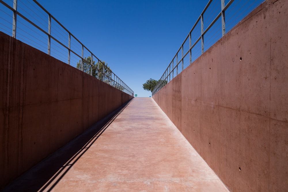 brown wooden bridge under blue sky during daytime