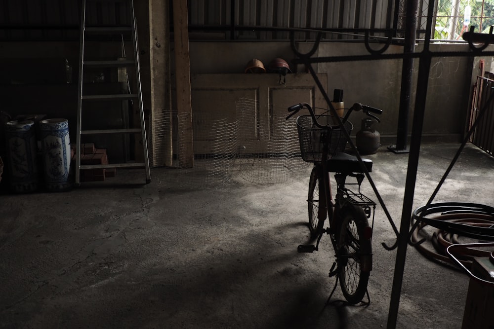 black bicycle parked beside brown wooden shelf