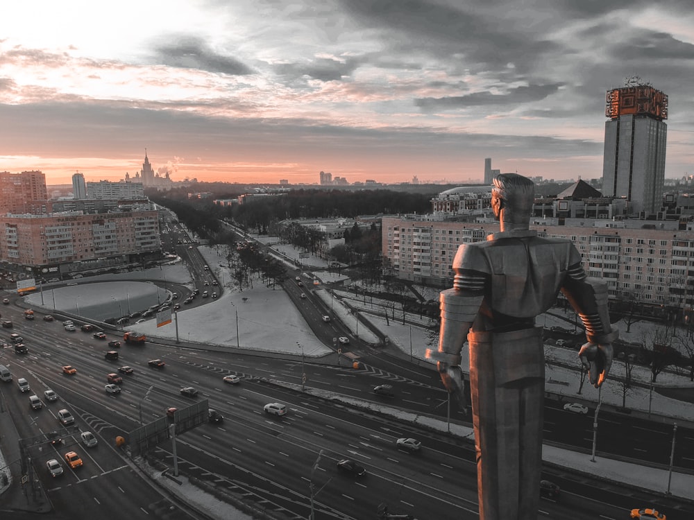 man in black jacket standing on top of building during daytime