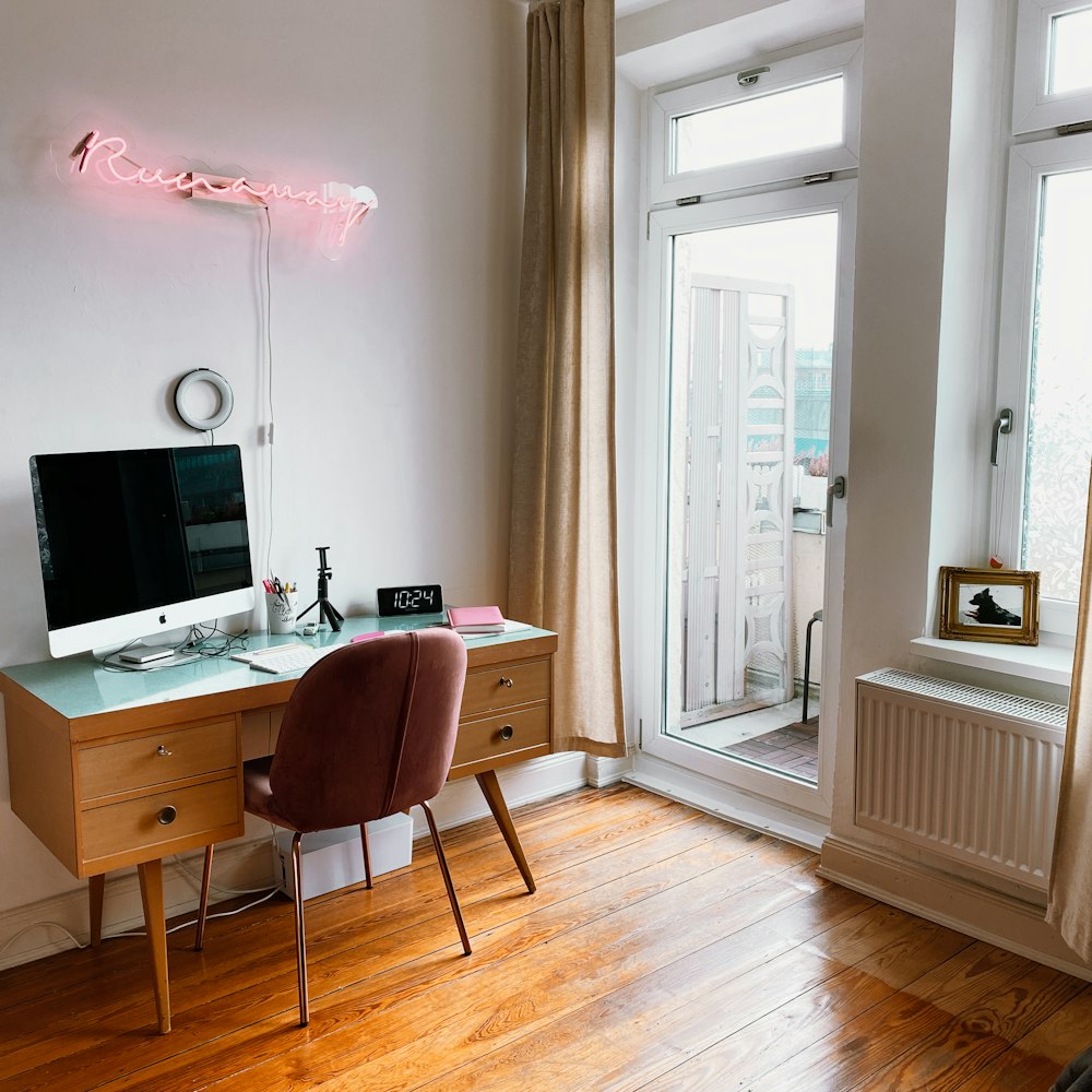 silver imac on brown wooden desk