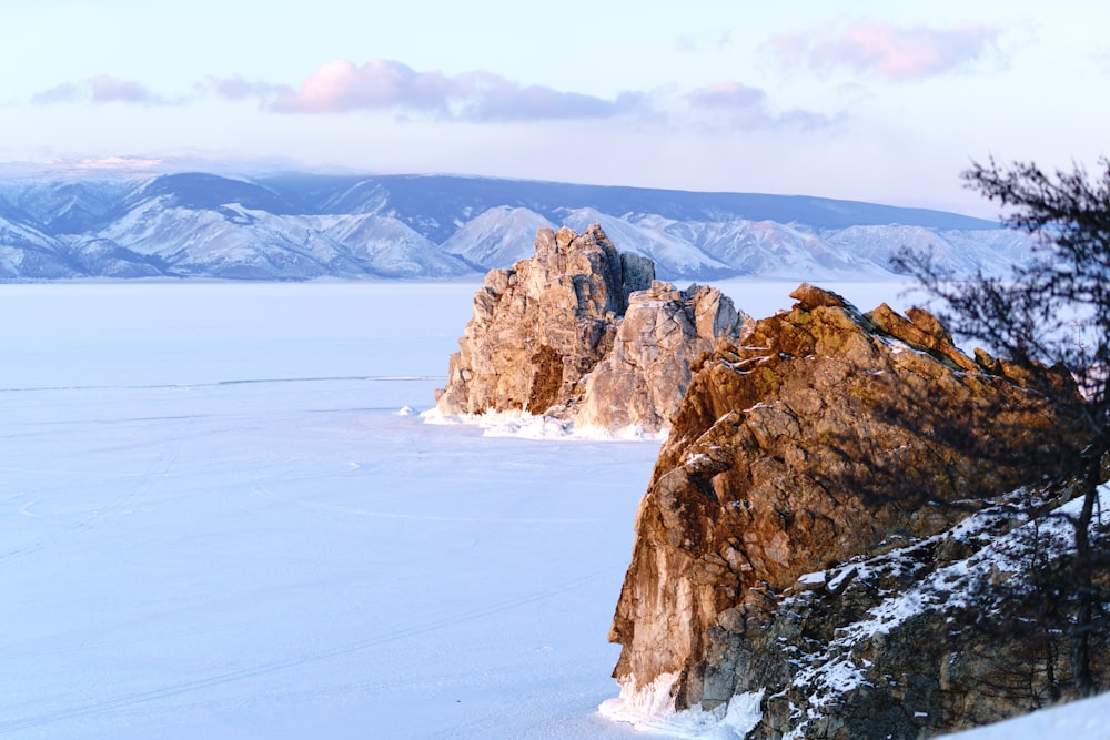 brown rock formation on snow covered ground during daytime