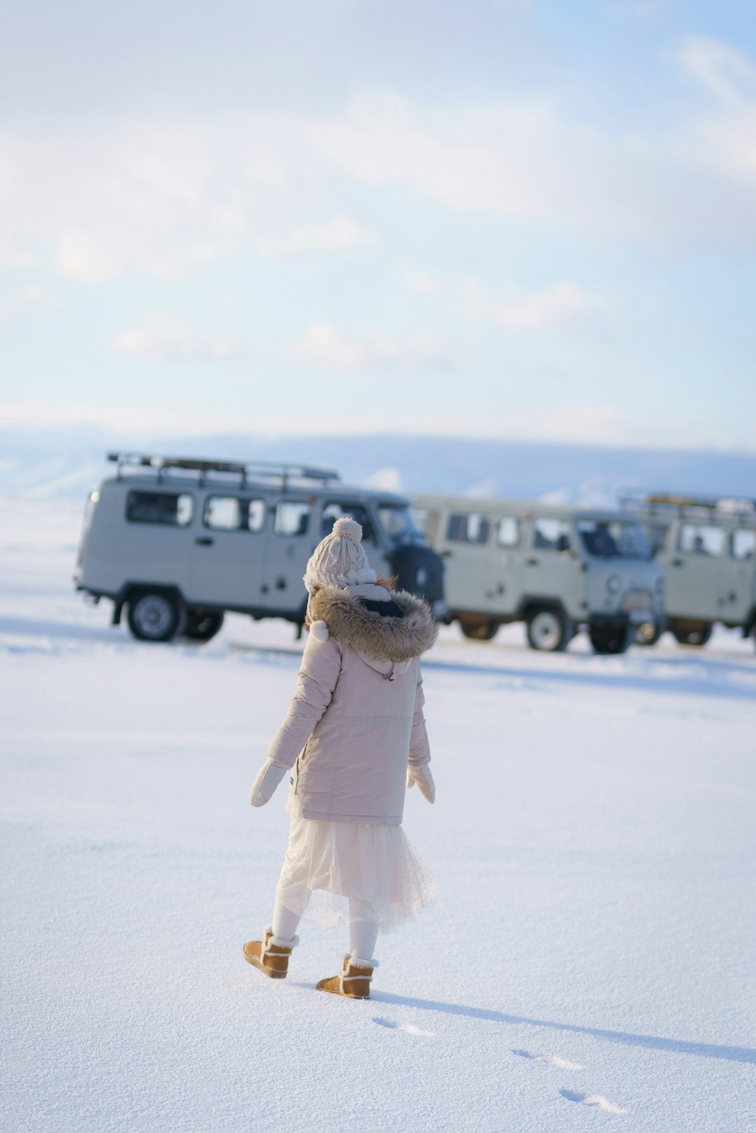 woman in white dress standing on snow covered ground during daytime