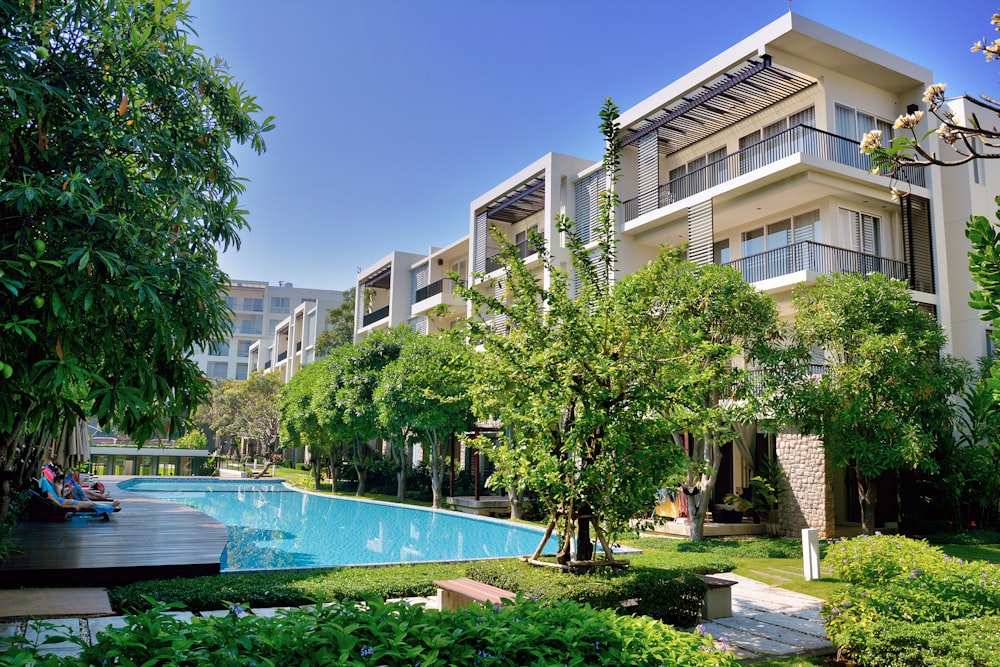 Green Trees Near Swimming Pool During Daytime