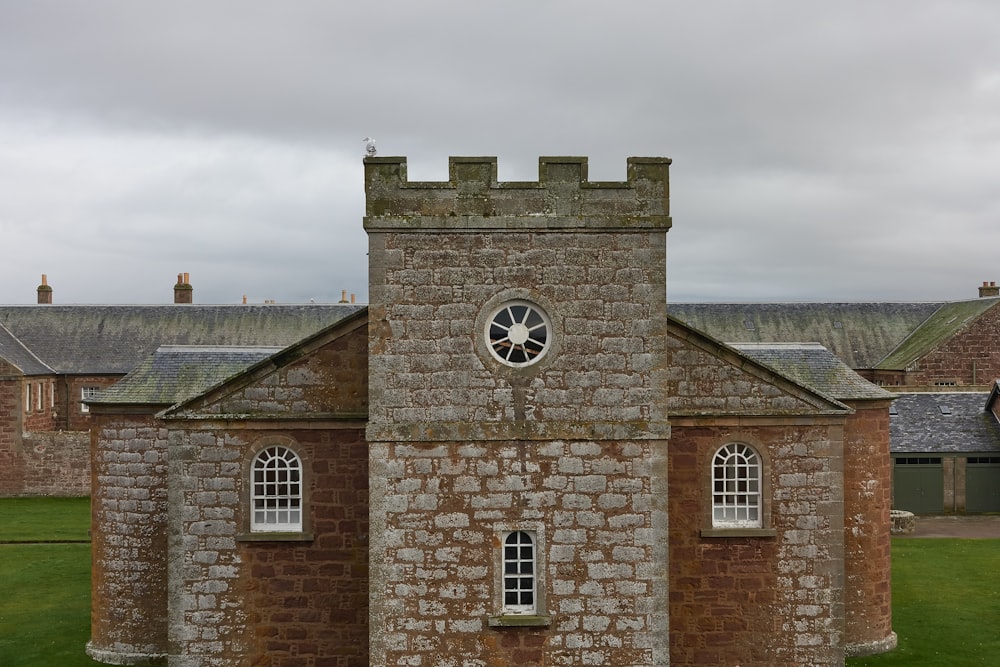 brown brick building with clock tower