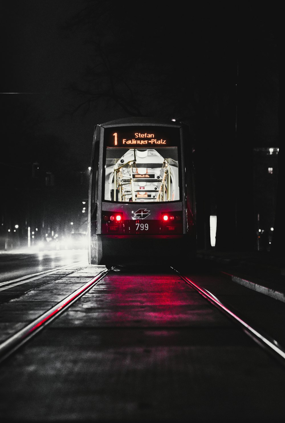 red and white bus on road during nighttime