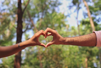 person in silver bracelet holding hands