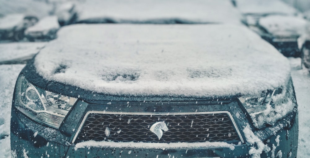 black and white car covered with snow