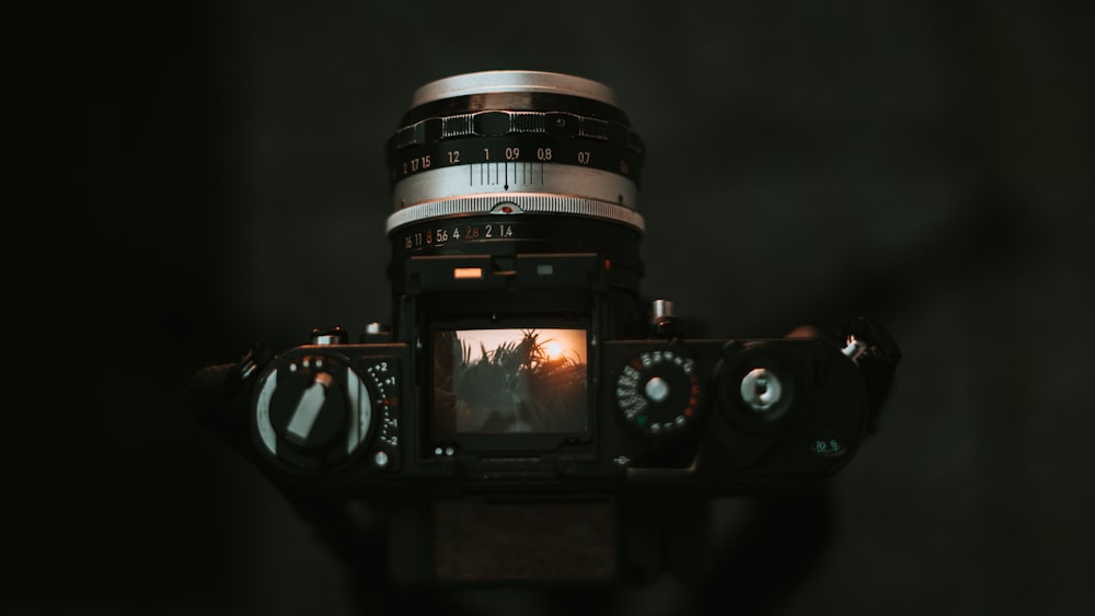 black dslr camera on brown wooden table