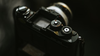 black dslr camera on brown wooden table