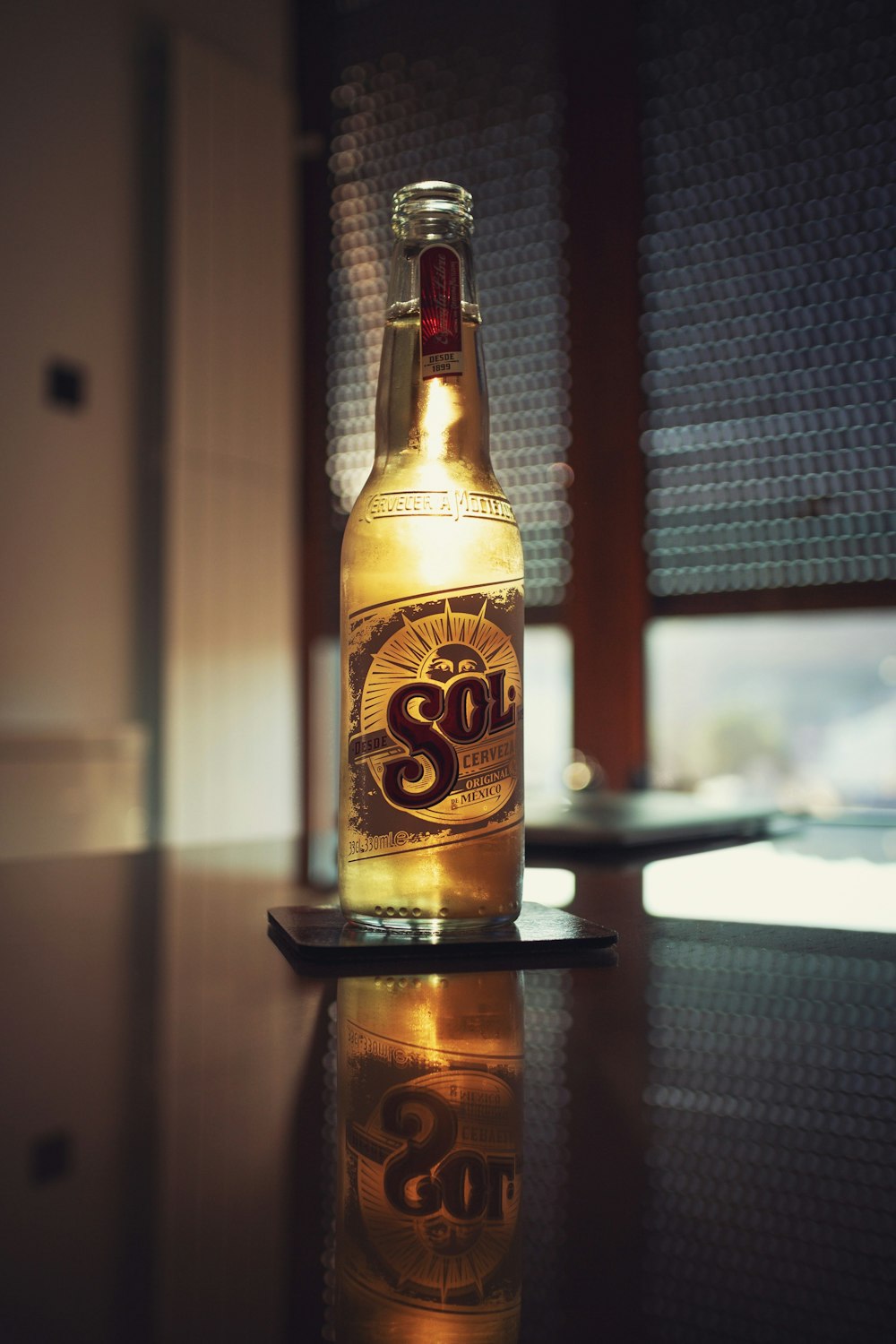 brown and yellow glass bottle on table