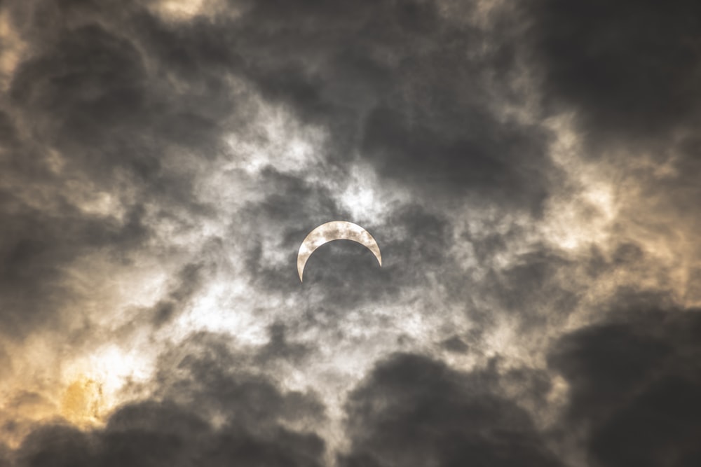 person in white parachute under gray clouds