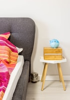 Compact bedroom setup featuring a space-saving bed and matching nightstand in a bright room.