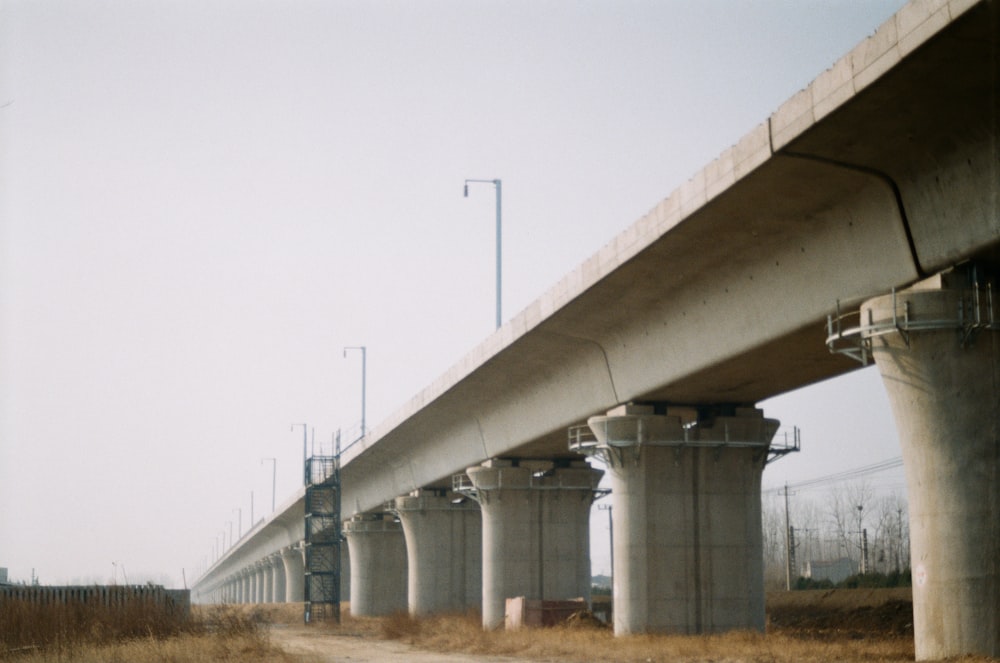 gray concrete bridge under gray sky during daytime