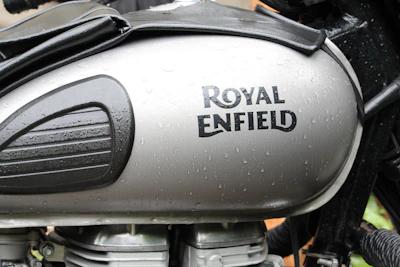Close-up of the iconic Royal Enfield logo on a gleaming fuel tank.