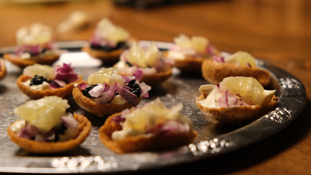 brown bread with purple and white toppings on black plate