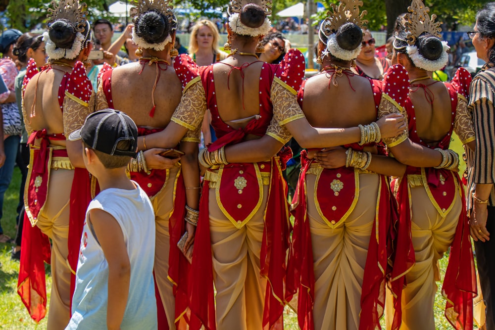 people in red and gold traditional dress