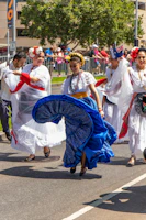 A crowd of joyful people in colorful carnival costumes dancing in the streets of Brazil.