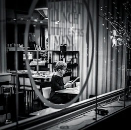 A mystery guest enjoying a meal at an elegant restaurant, blending in seamlessly.