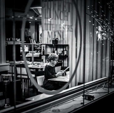 A mystery guest enjoying a meal at an elegant restaurant, blending in seamlessly.