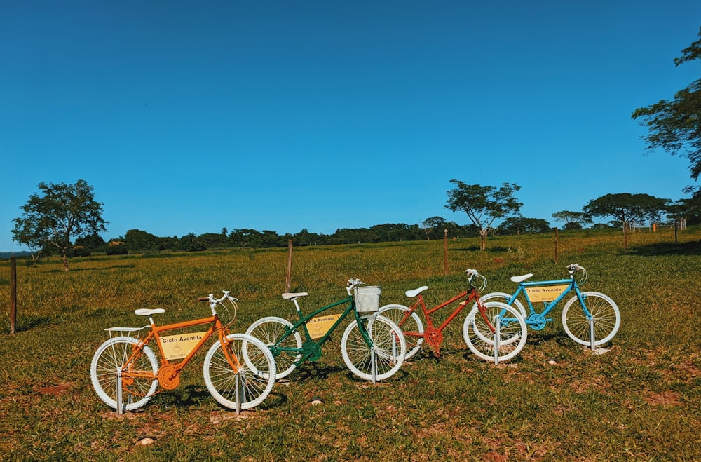 red and white commuter bike on green grass field during daytime