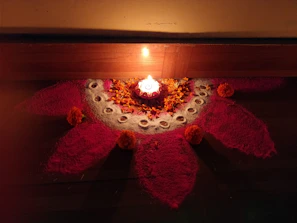 A festive arrangement featuring a vibrant rangoli kit with colorful powders and tools laid out neatly on a minimalist table.