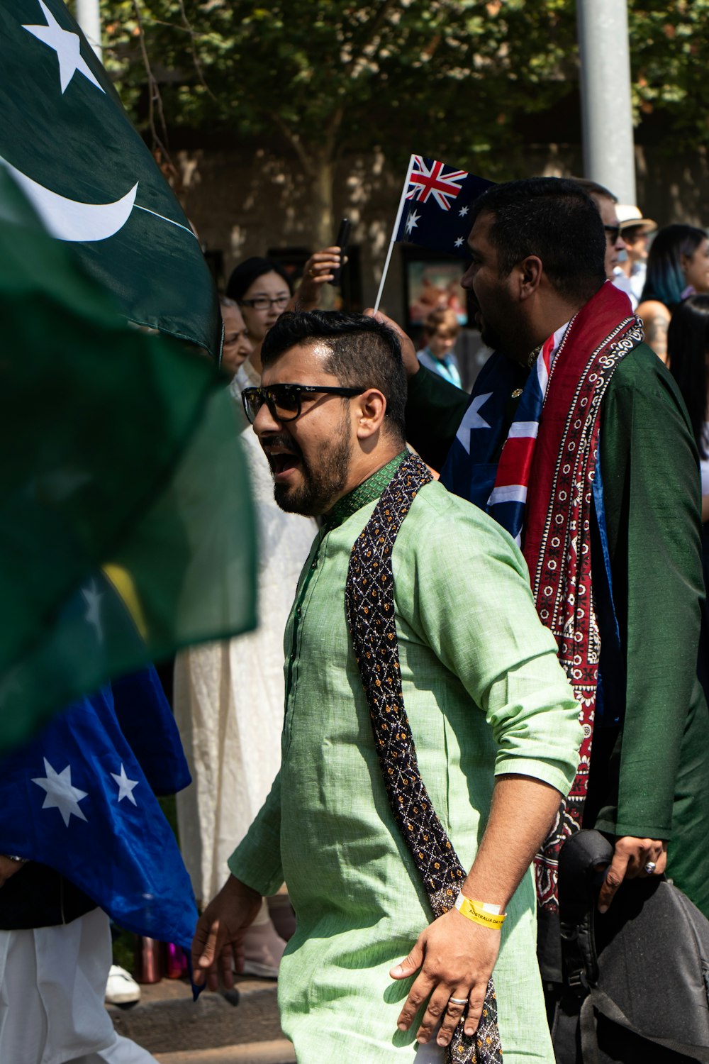 man in green long sleeve shirt wearing black sunglasses