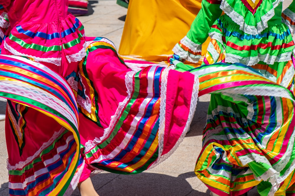 person in yellow shirt and multi color skirt