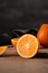 sliced orange fruit on brown wooden table