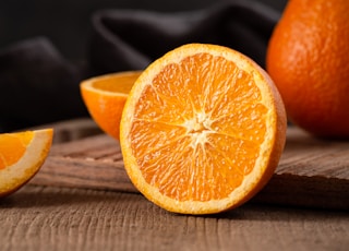 sliced orange fruit on brown wooden table